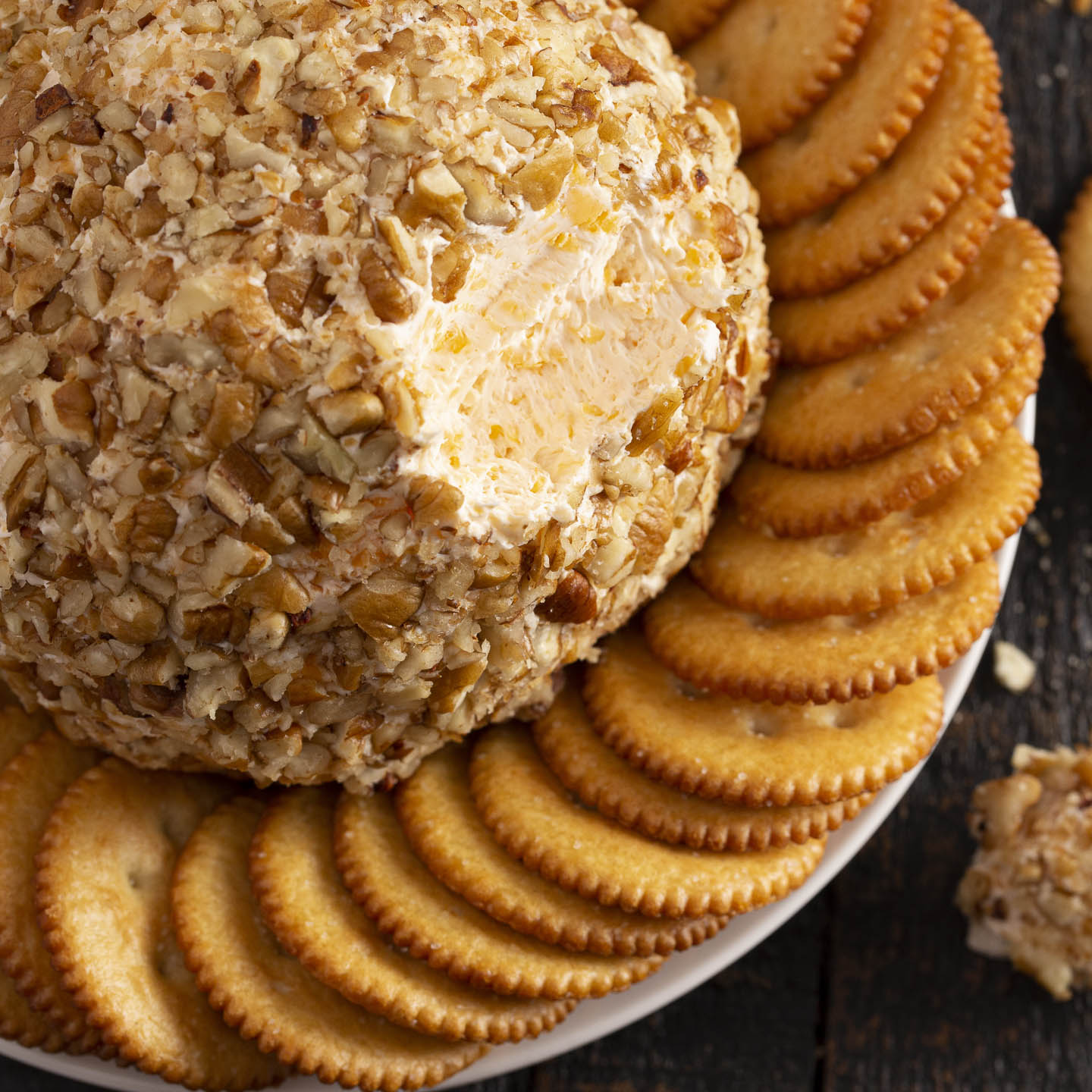 triple cheese ball with crackers on a plate