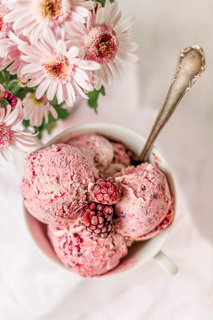 one view of a bowl of ice cream with berries