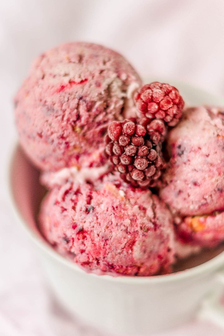 close view of no churn berry ice cream with frozen berries