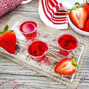 strawberry apple jello shots on a tray