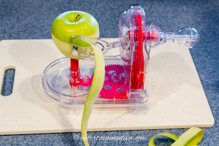 An apple being peeled with an apple peeler machine