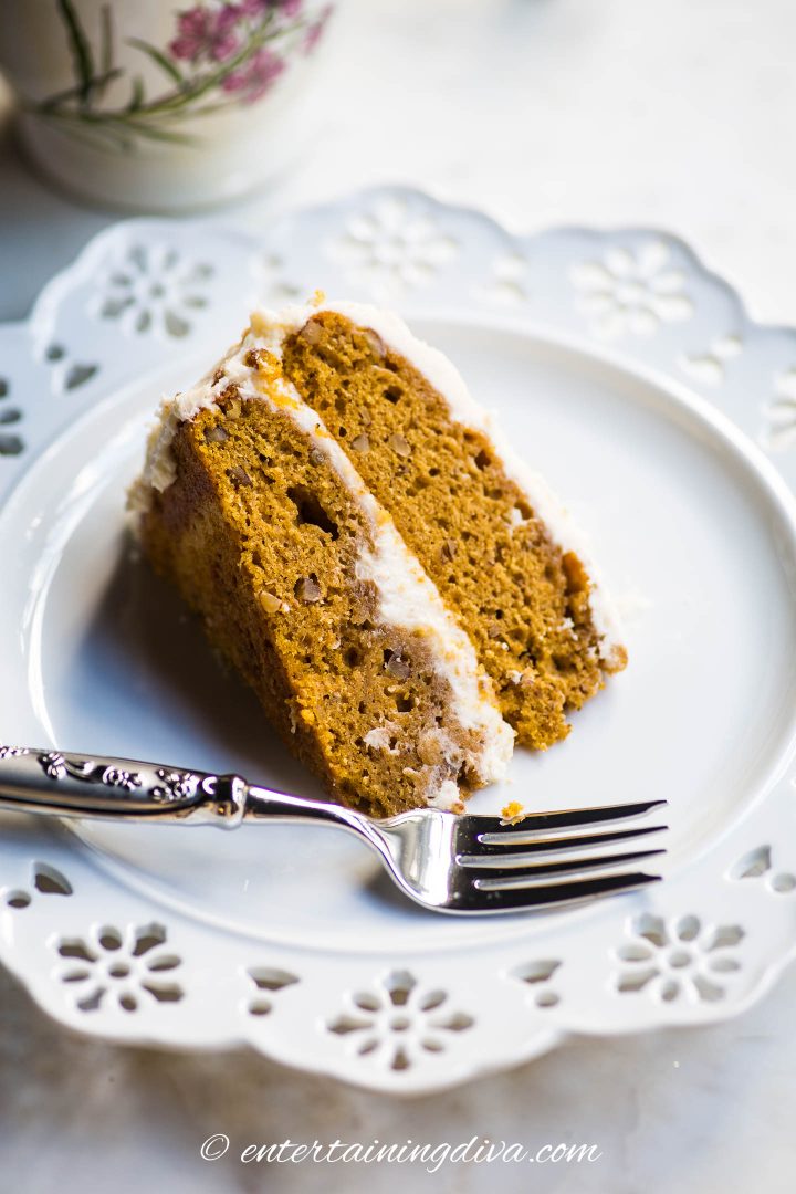 pumpkin spice cake on a white plate with a fork