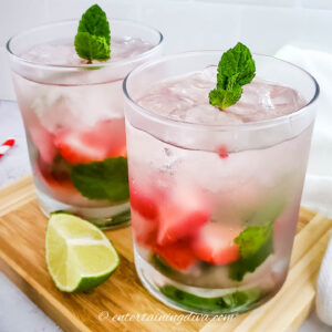 strawberry mint mojitos in glass with ice and lime