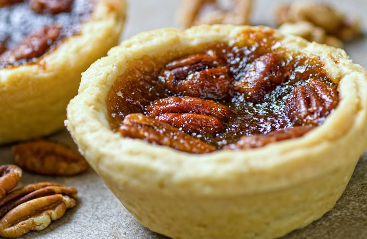butter tarts with pecans on the top