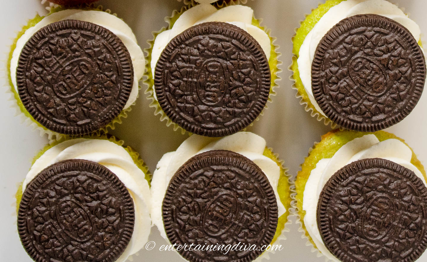 Oreo cookies on cupcakes with frosting