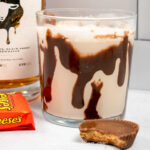 peanut butter cup whiskey cocktail with reese's peanut butter cup in front