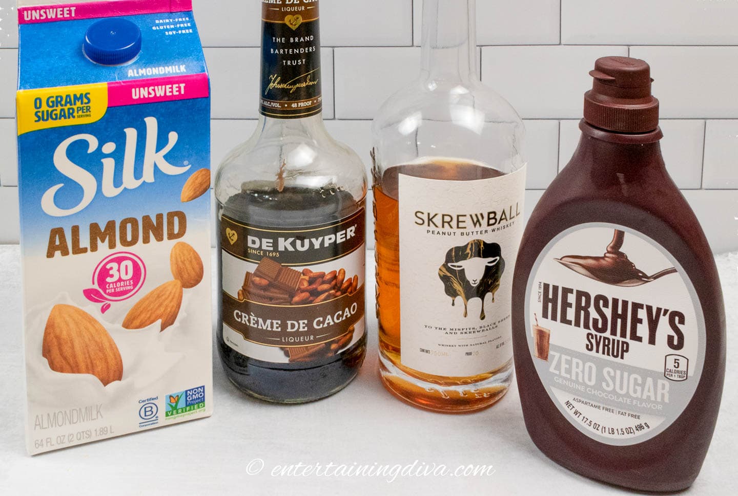 peanut butter cup whiskey cocktail ingredients - milk, creme de cacao, skrewball whiskey and chocolate syrup