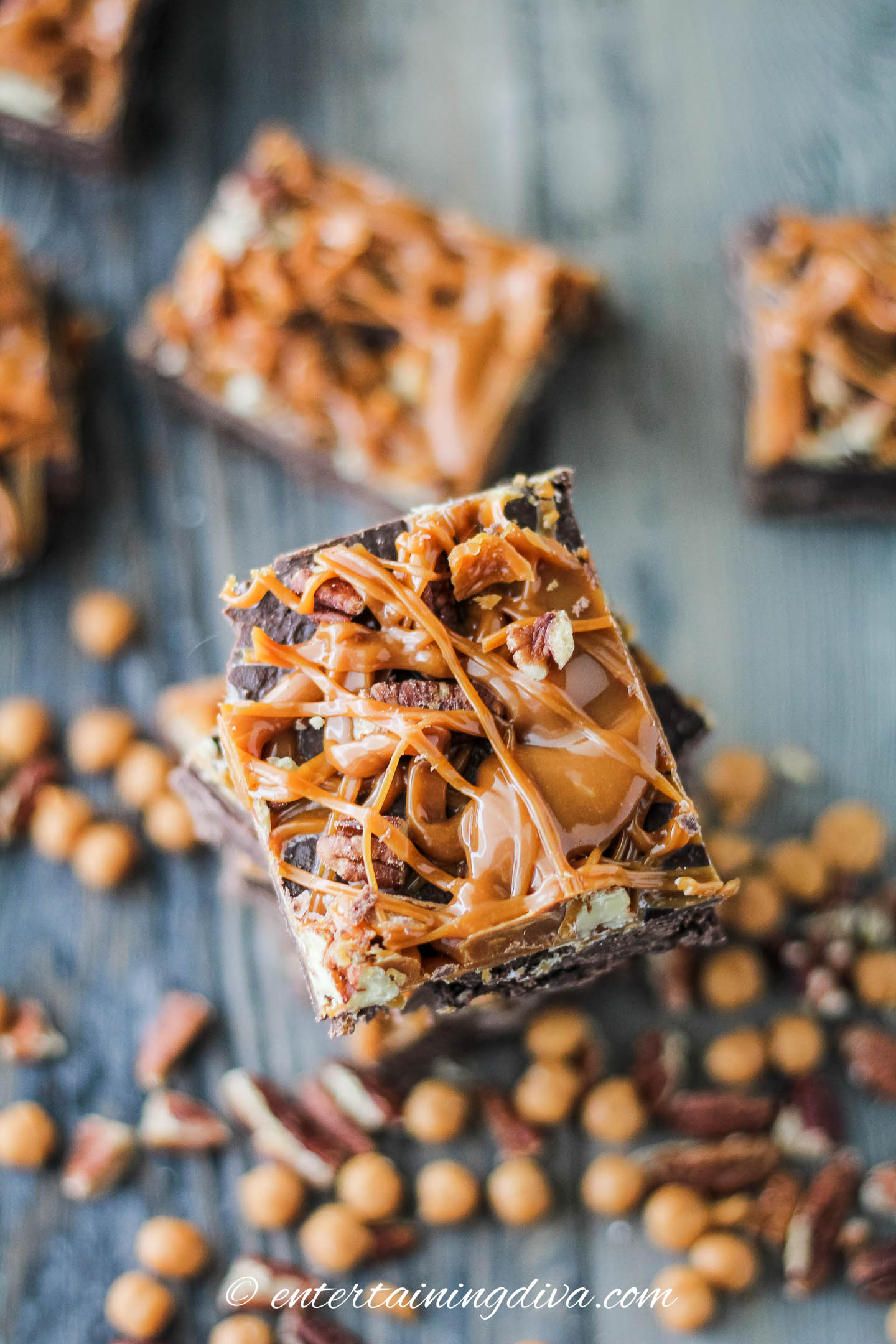 one chocolate cream cheese fudge bar with caramel and pecans