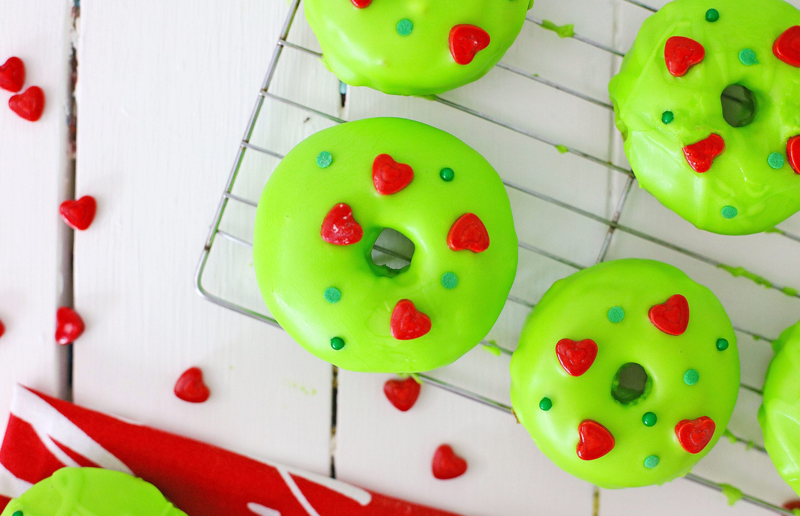 green Grinch donuts on a wire rack