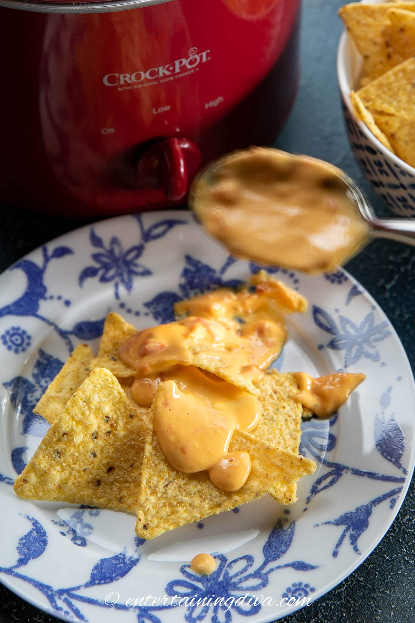 Tortilla chips with Rotel cheese dip on a plate 