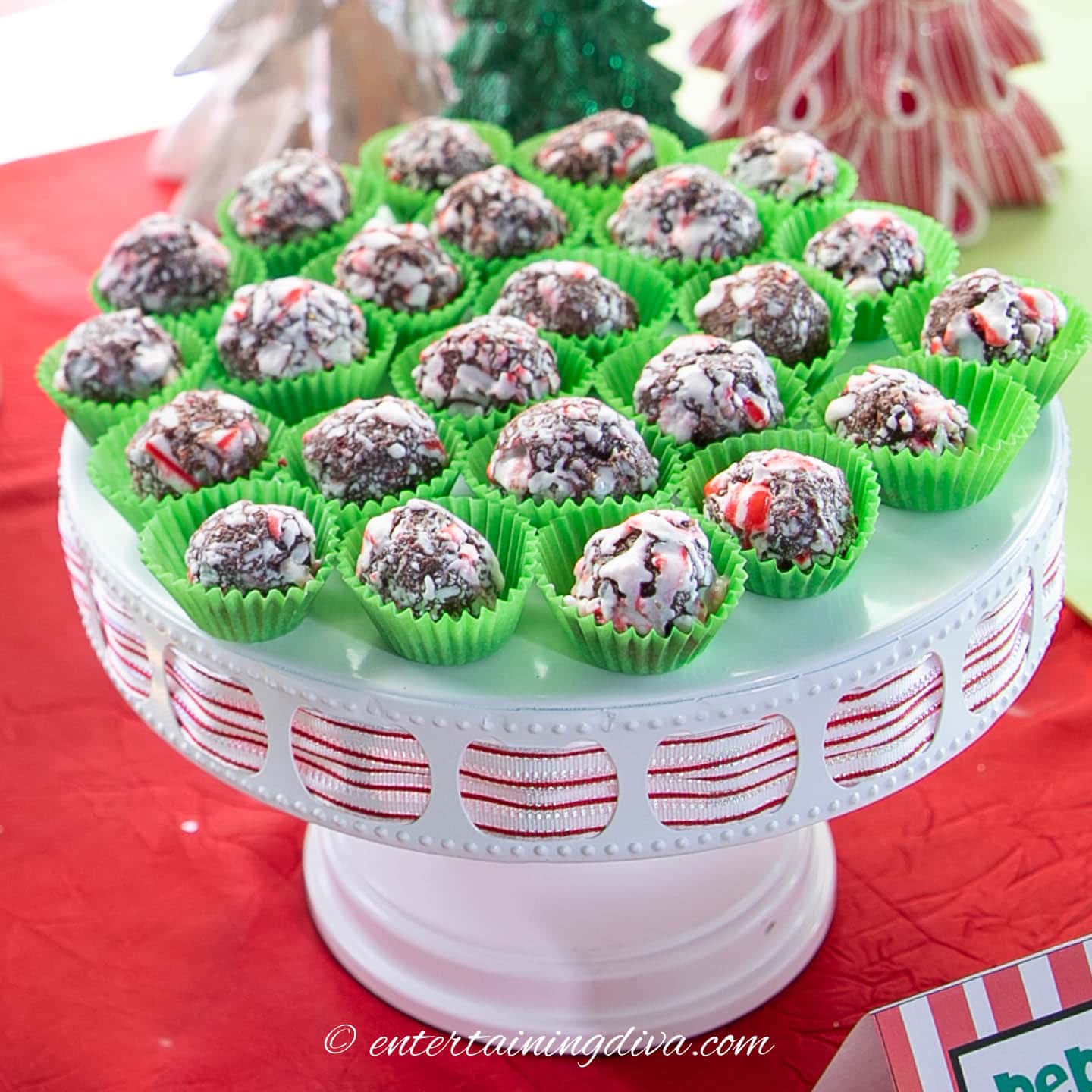peppermint chocolate fudge balls in green wrappers on a cake plate
