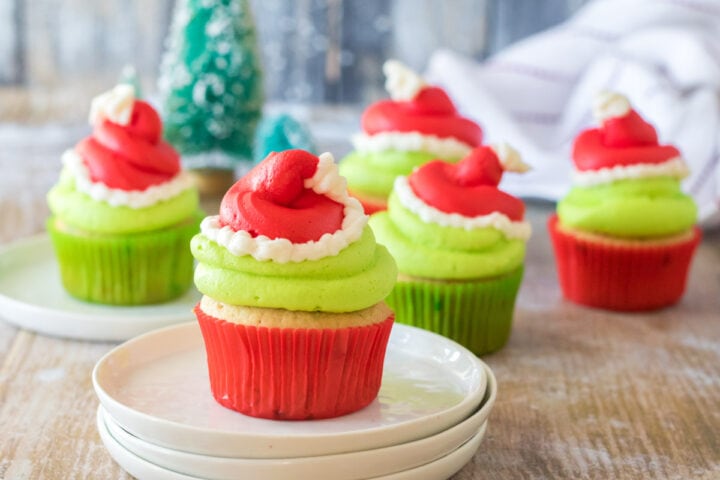 peppermint grinch cupcakes with red santa hat frosting
