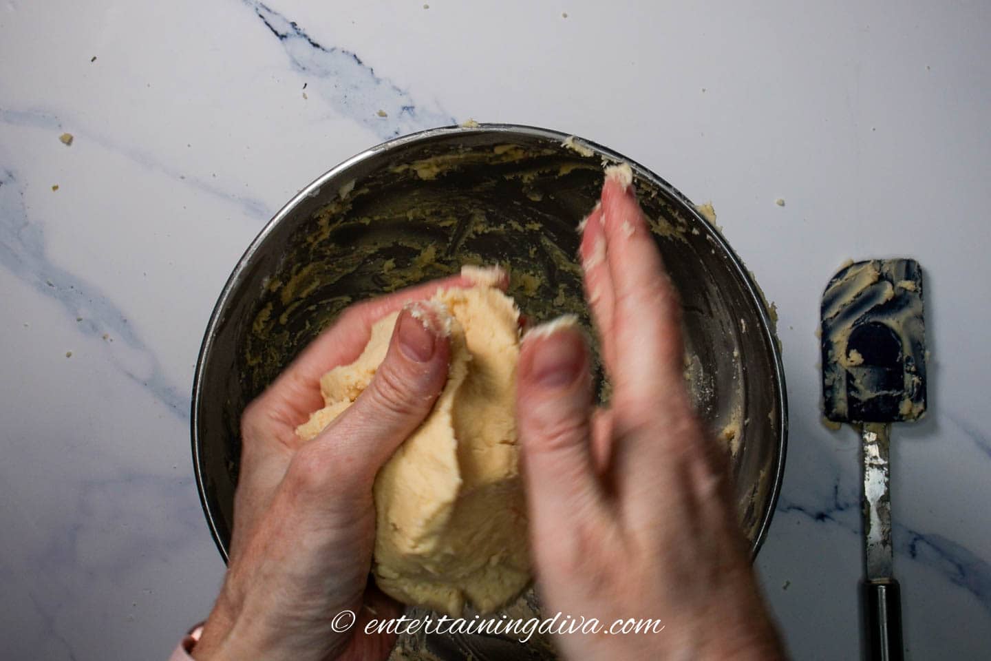 Forming the whipped shortbread cookie dough into a ball