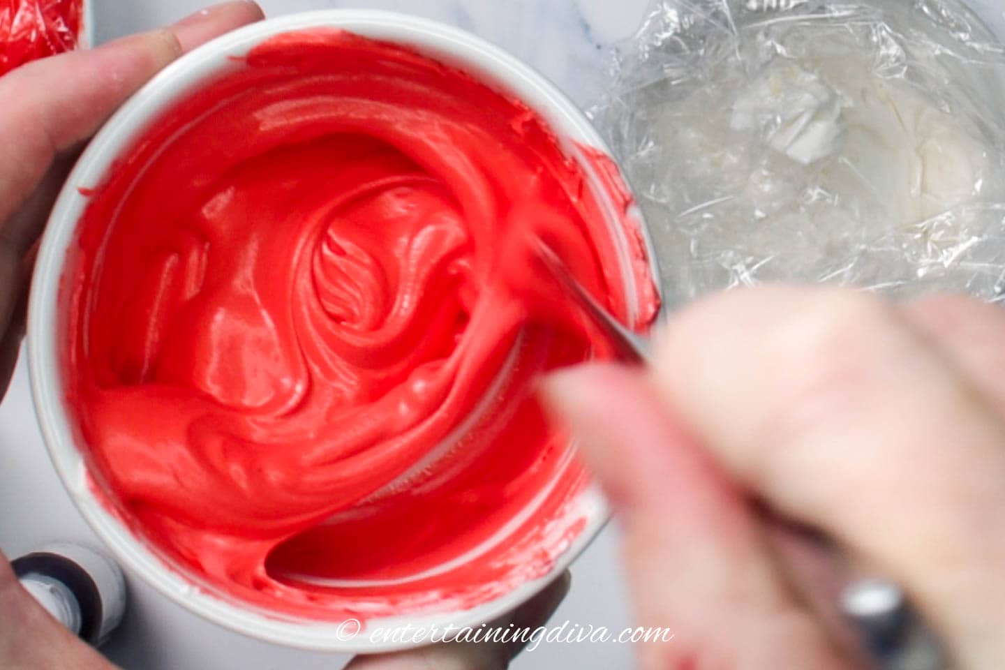 red royal icing being mixed