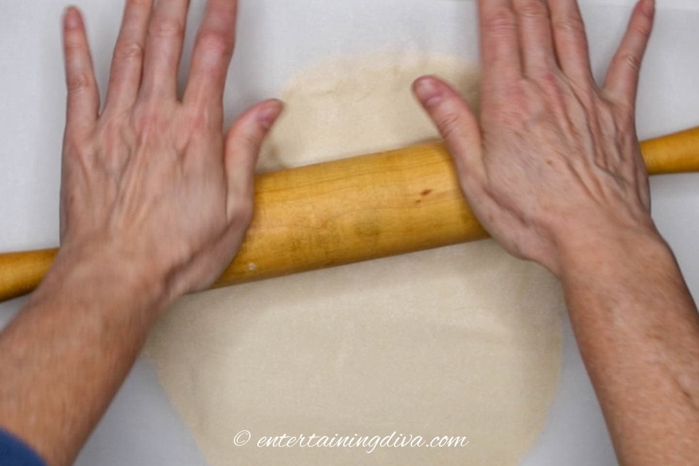 cookie dough being rolled out with a rolling pin