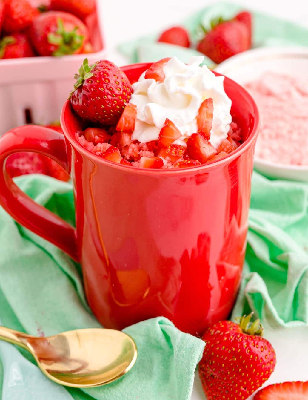 strawberry mug cake in a red cup