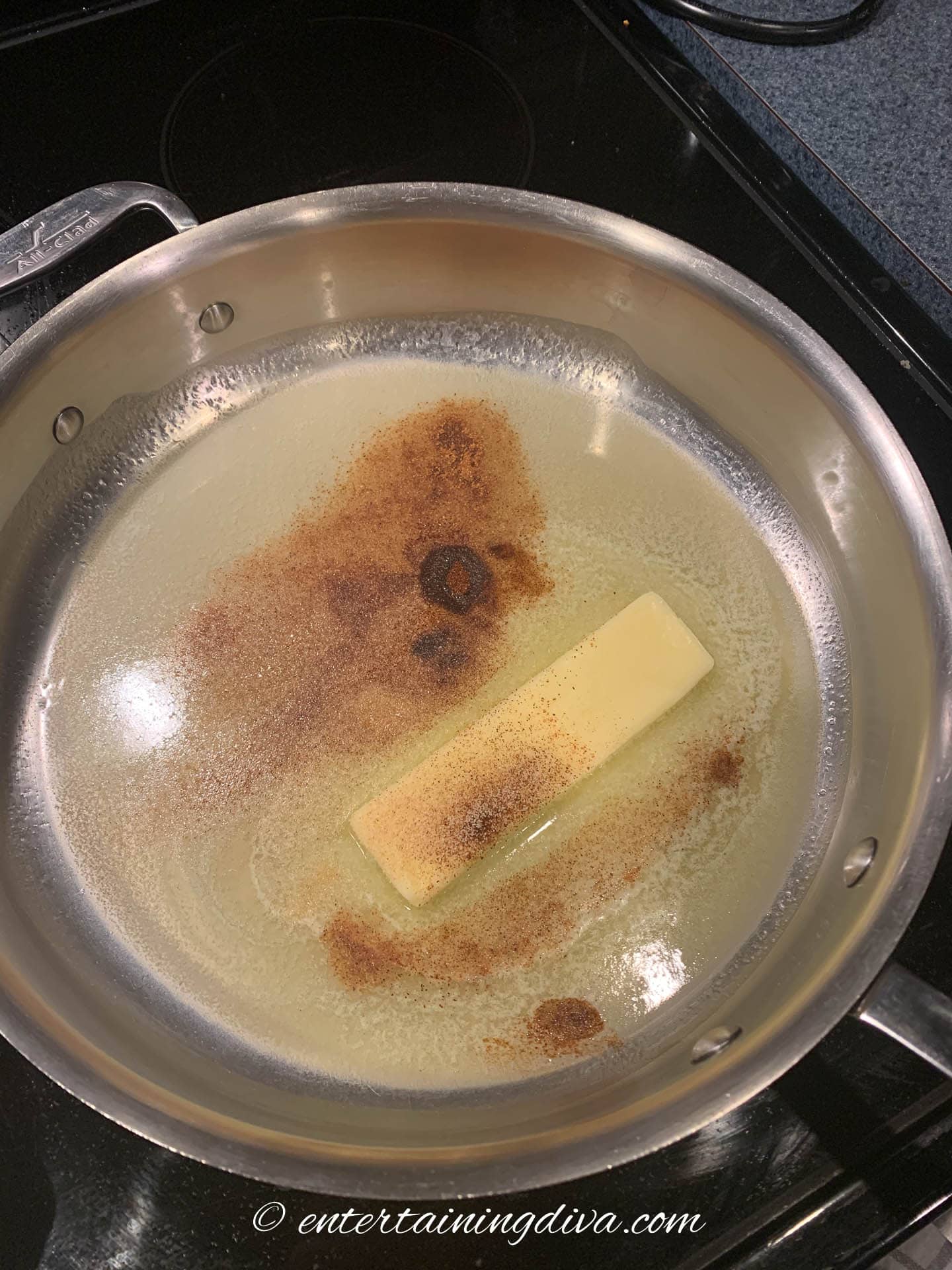 butter melting in a frying pan with garlic powder
