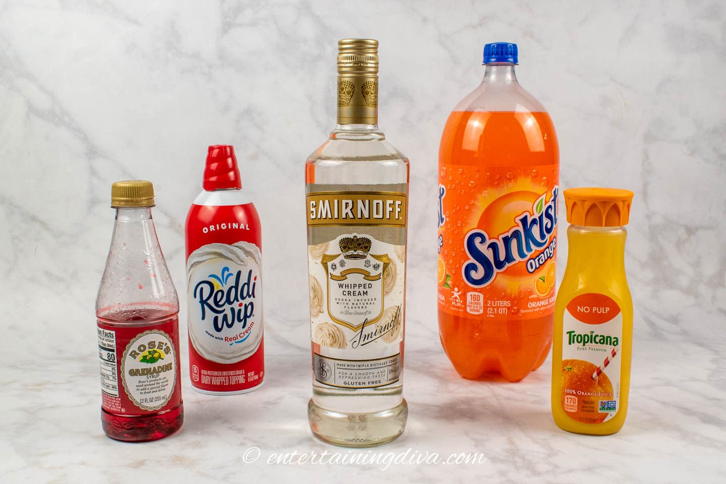 orange creamsicle cocktail ingredients: grenadine, Reddi Wip, whipped cream vodka, orange soda and orange juice