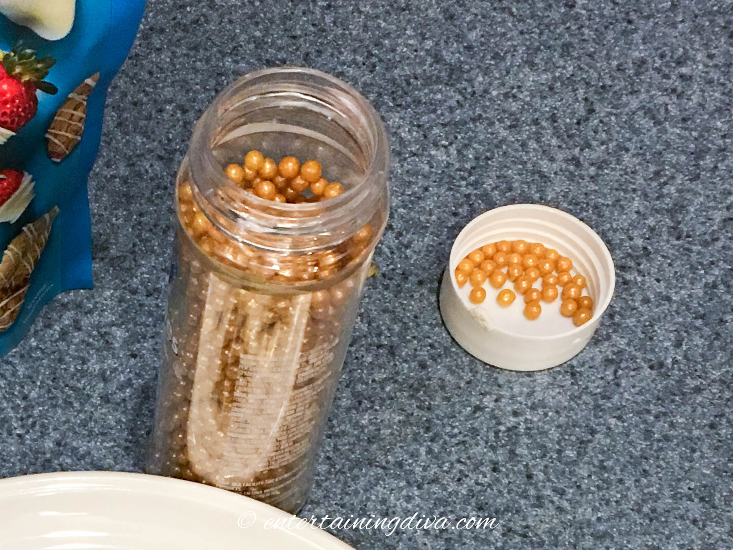 a bottle of gold sugar balls on the counter
