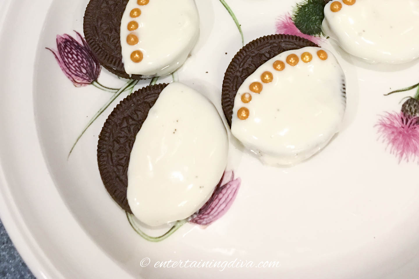 Oreos dipped in white chocolate on a plate