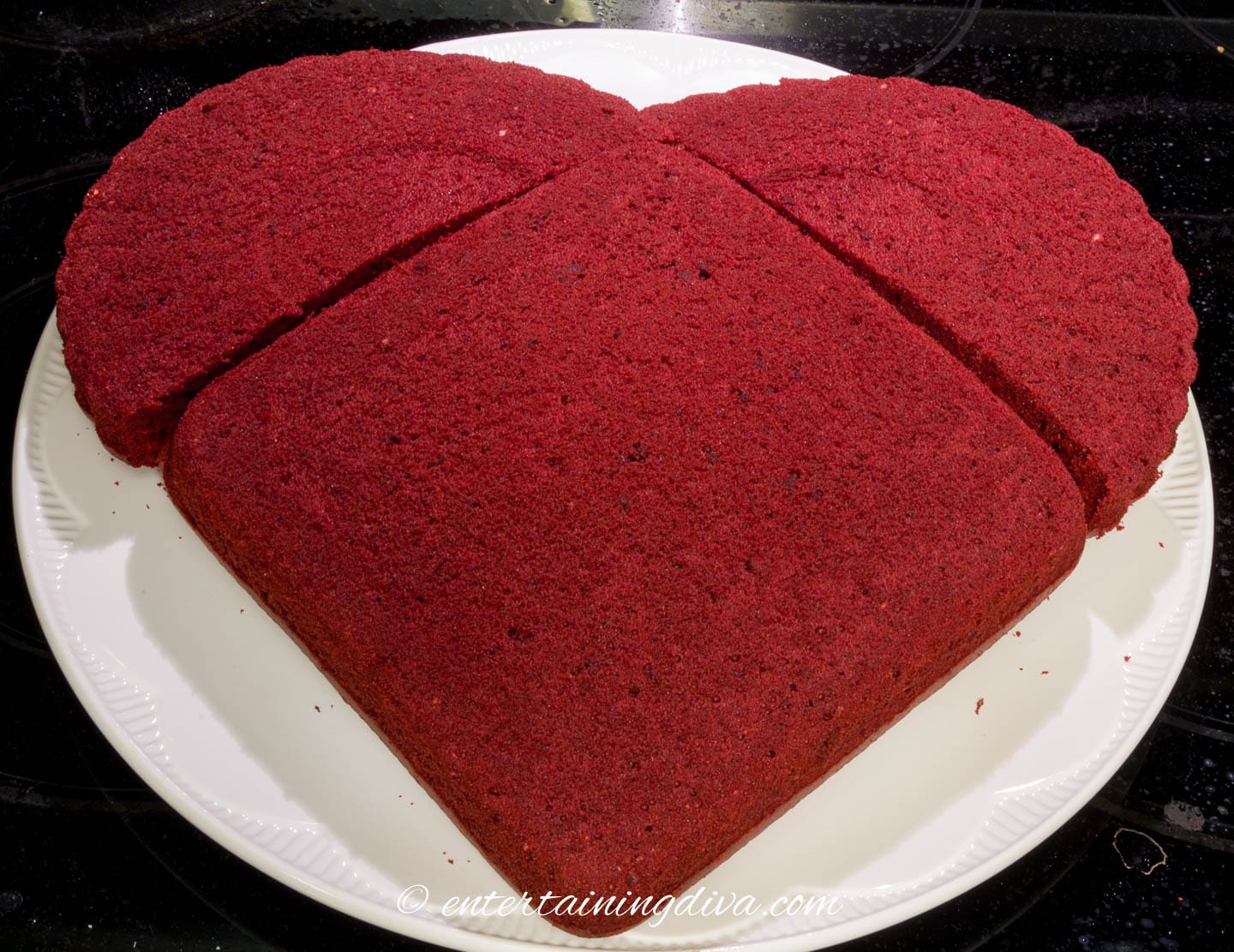 heart shaped cake made from two halves of a round cake pushed up against the flat sides of a square cake