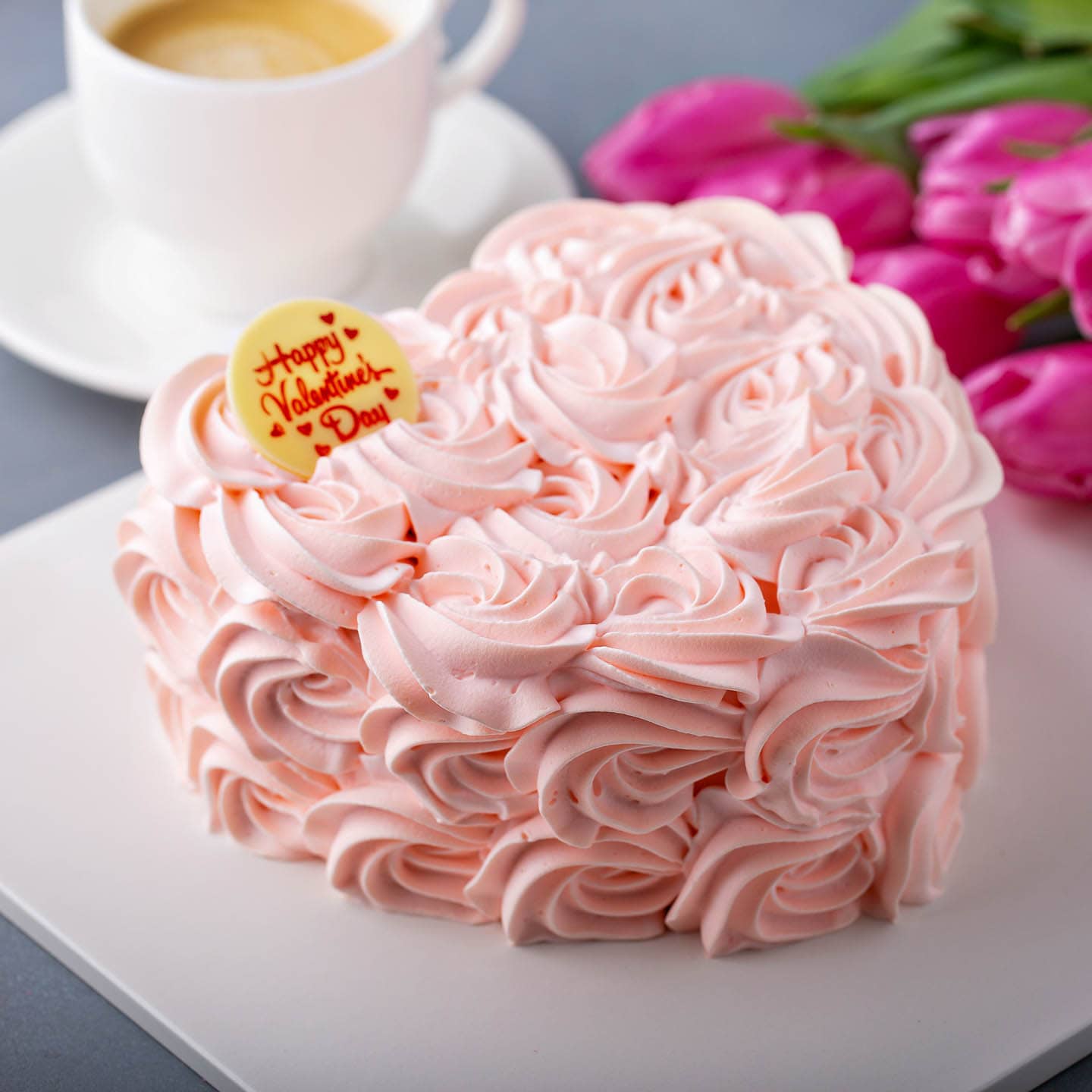 heart shaped cake with pink icing roses