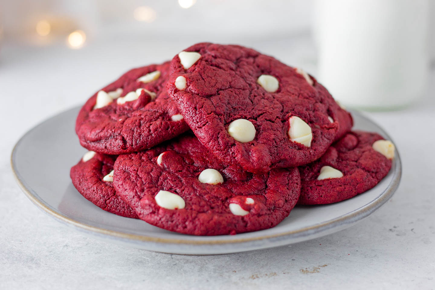 a pile of red velvet cake mix cookies with white chocolate chip son a plate