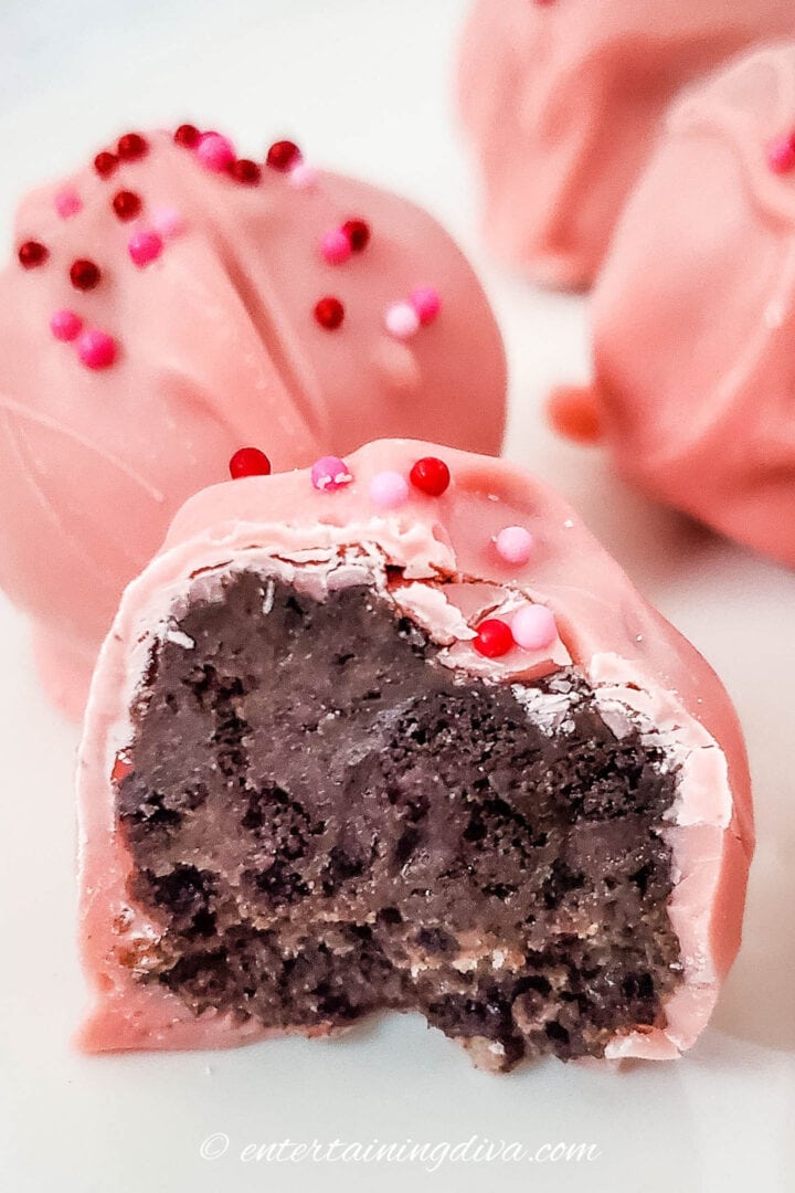 Close up of a Valentine Oreo ball with a bite out of it