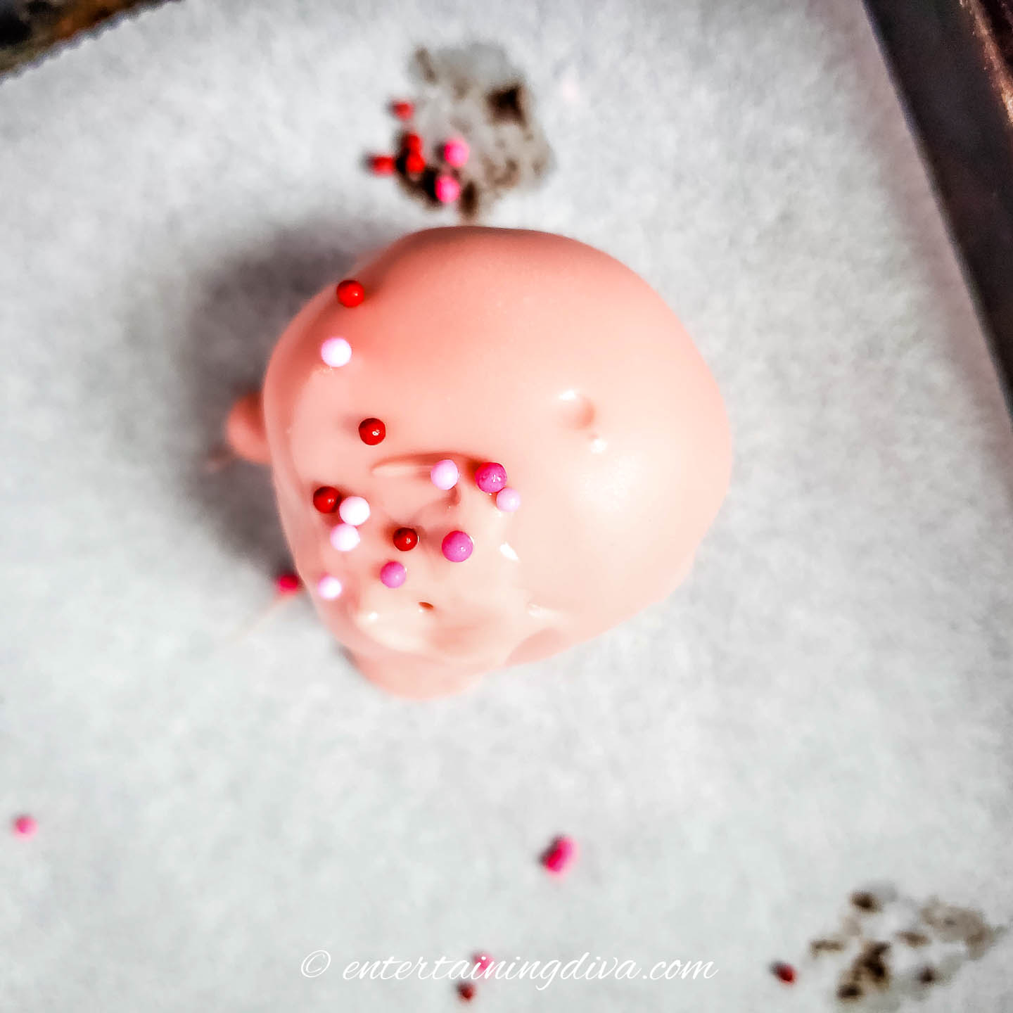 Oreo ball with pink coating and sprinkles