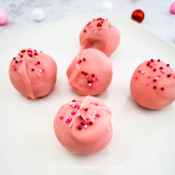 pink Valentine Oreo balls with sprinkles on a plate