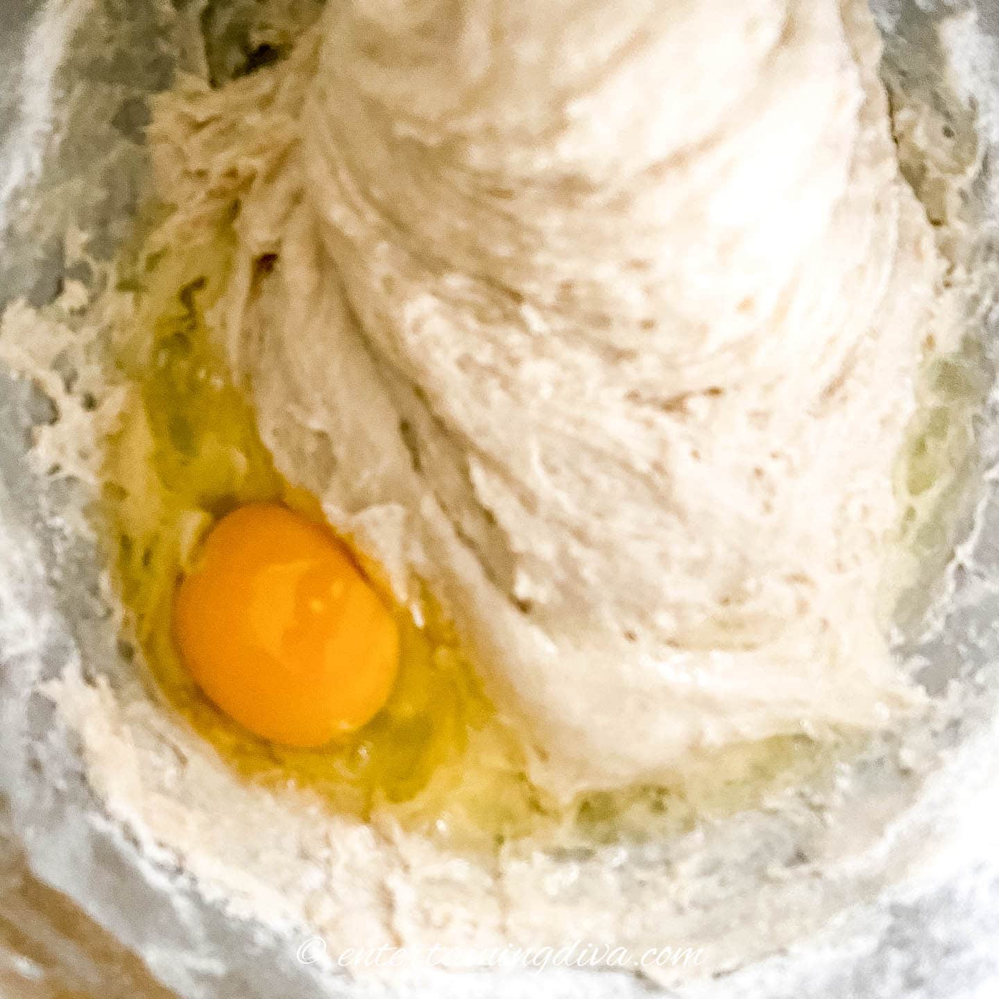 Egg and cinnamon roll dough in a mixing bowl