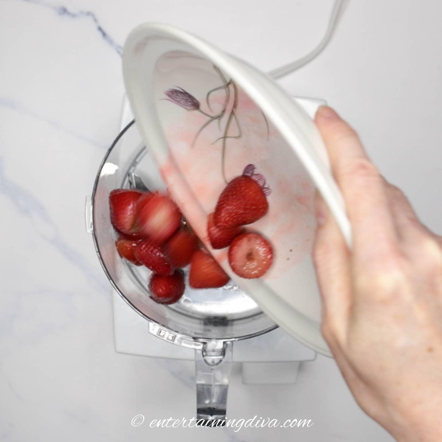 strawberries being added to a food processor