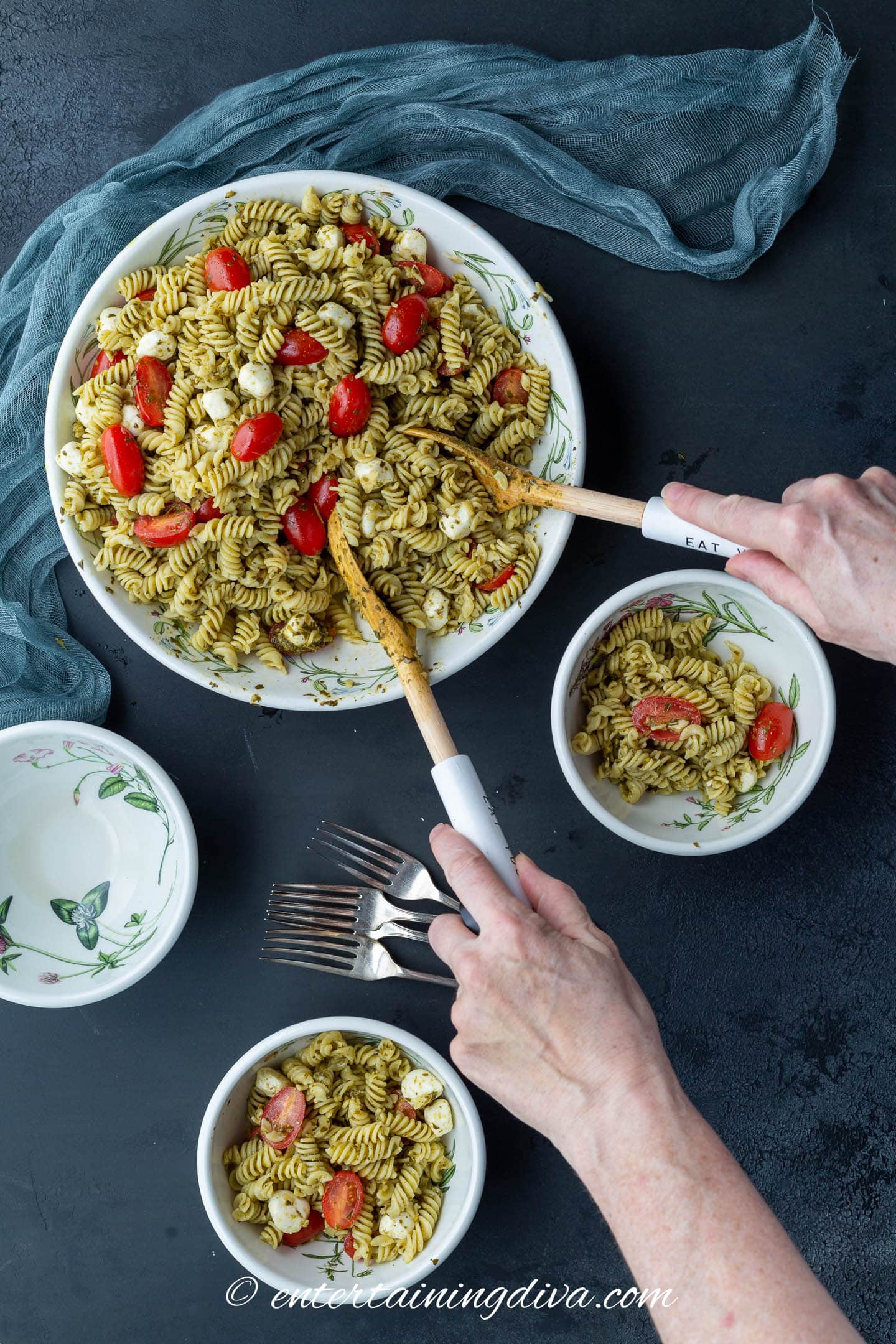 4-ingredient pasta salad in a large bowl being served into a smaller bowl