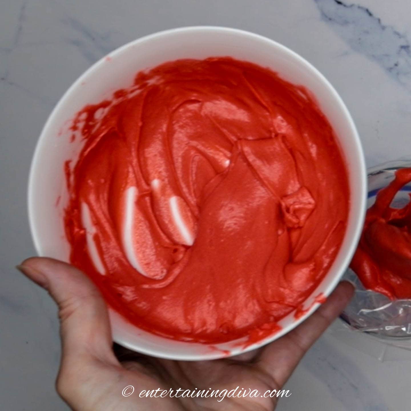 A bowl of red icing