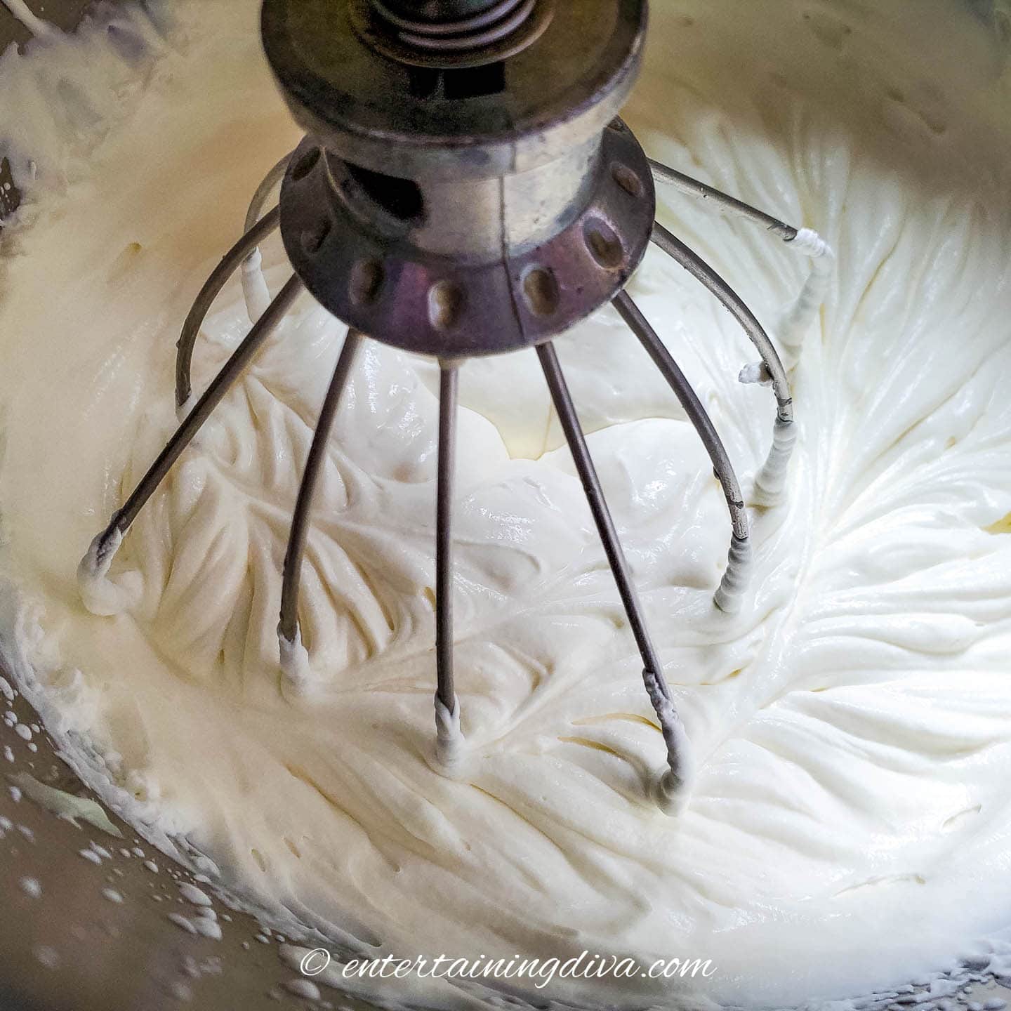 beater mixing whipping cream and sweetened condensed milk together
