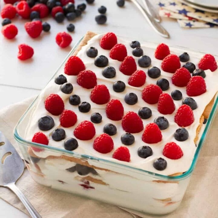 no-bake icebox cake topped with raspberries and blueberries