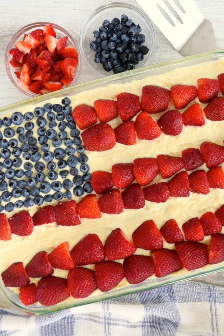 ice box cake decorated with blueberries and strawberries to look like the American flag