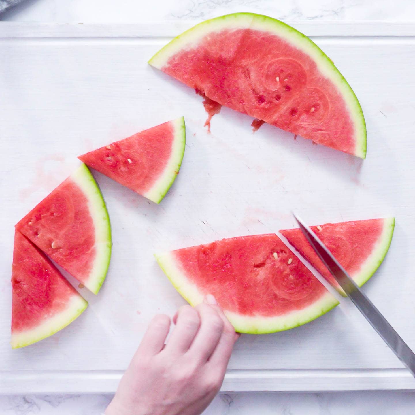 watermelon being cut into wedges