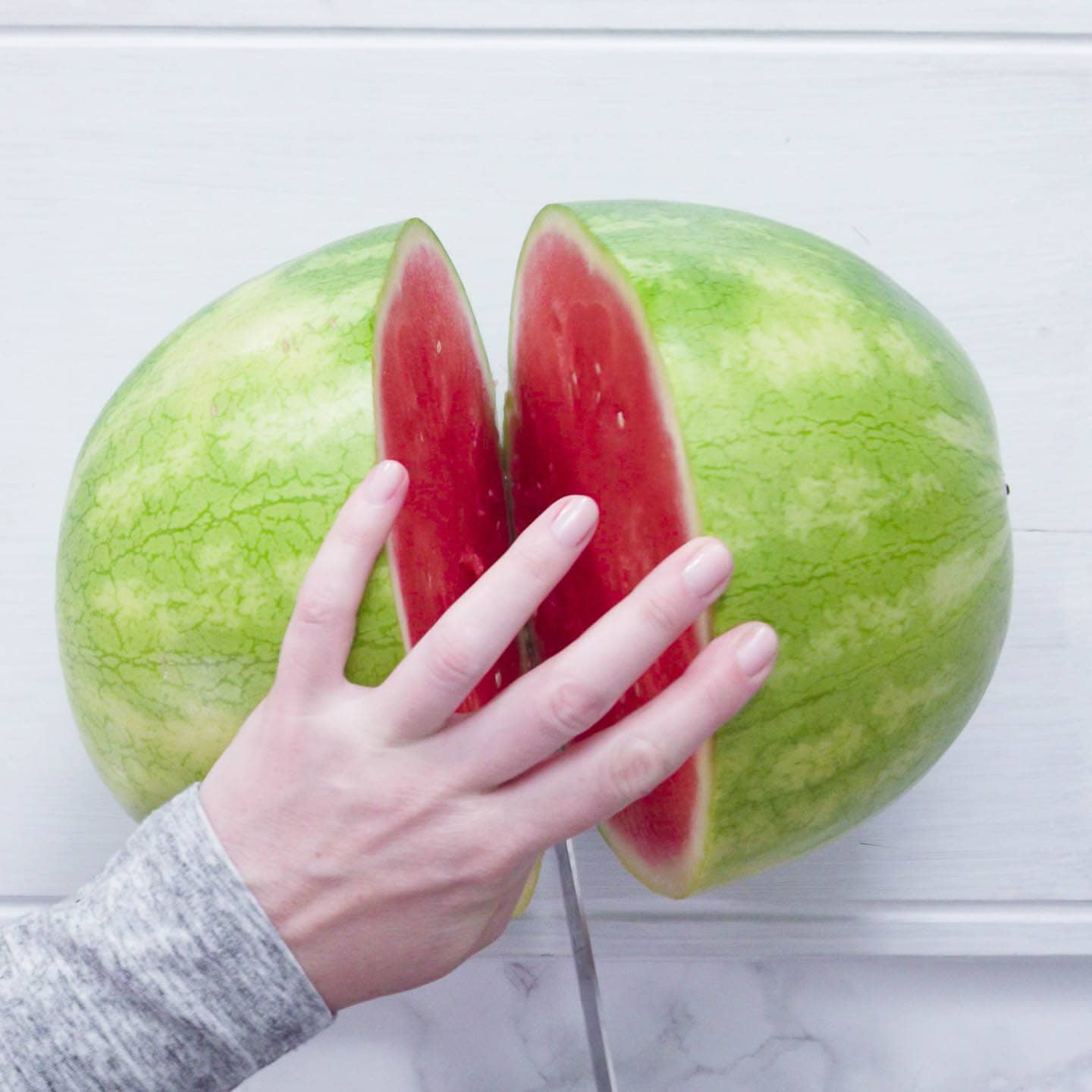watermelon being cut in half