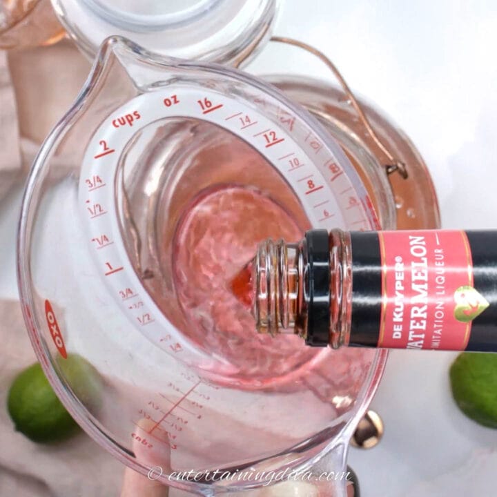 watermelon pucker being poured into a measuring cup