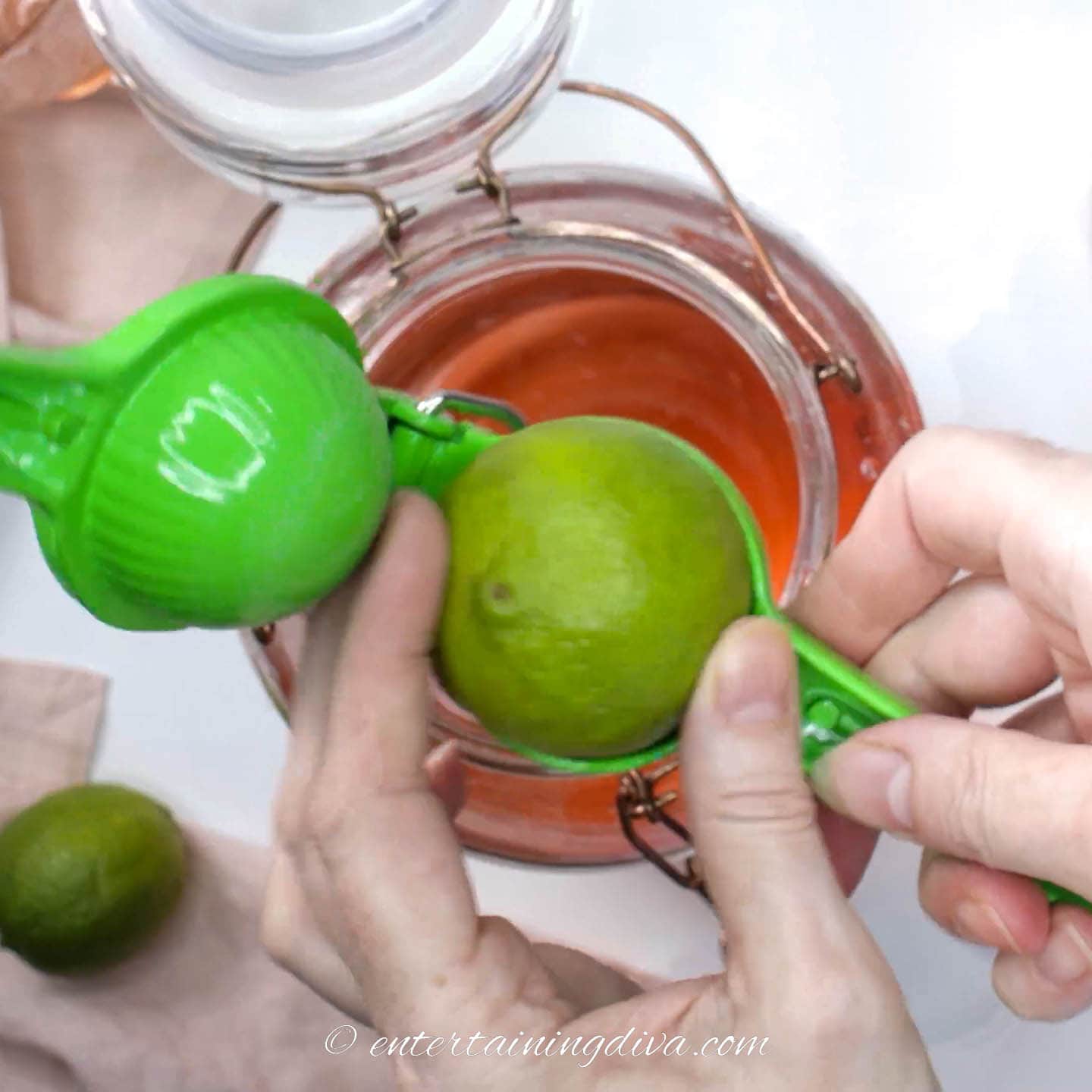 lime being put into a juicer