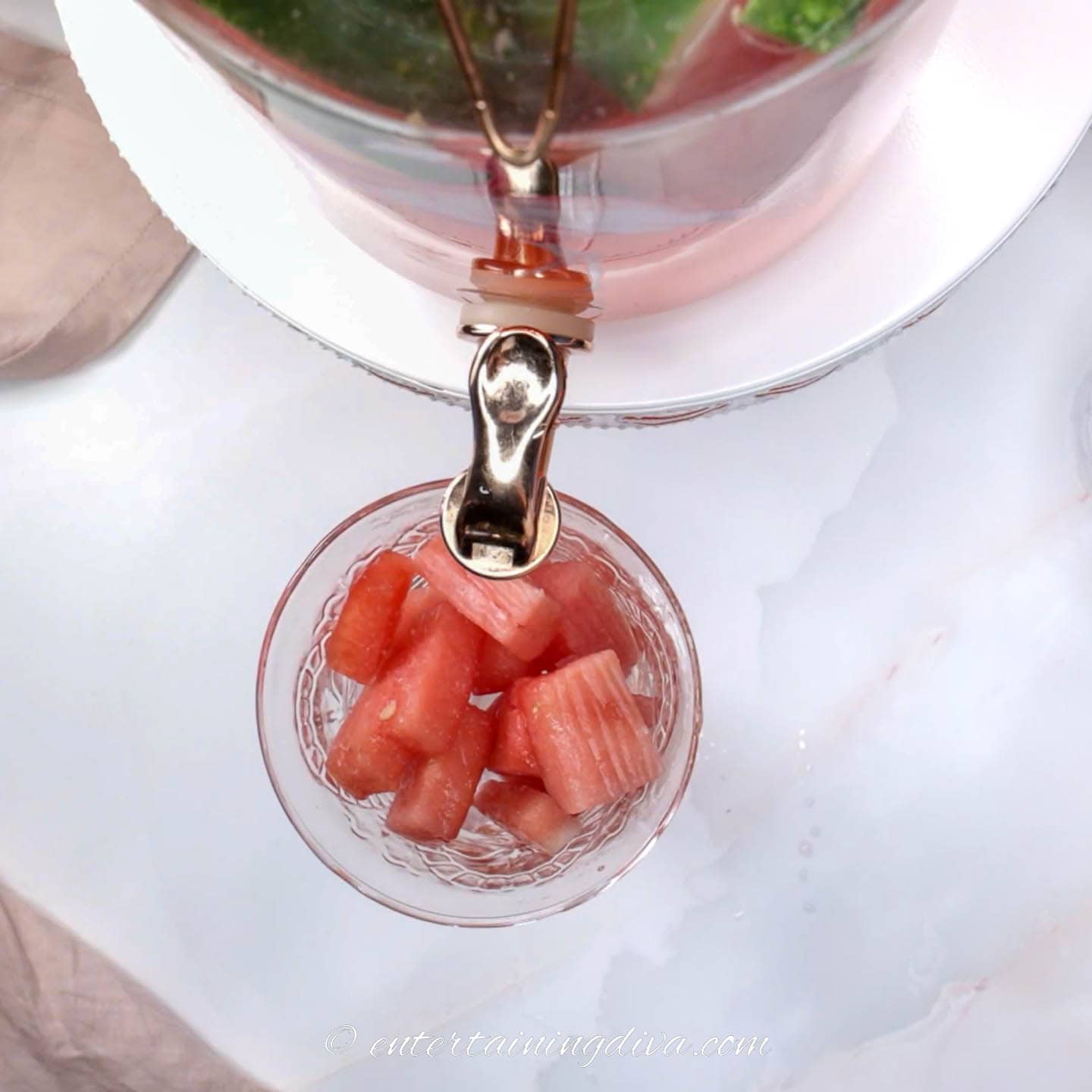 glass with watermelon cubes in it