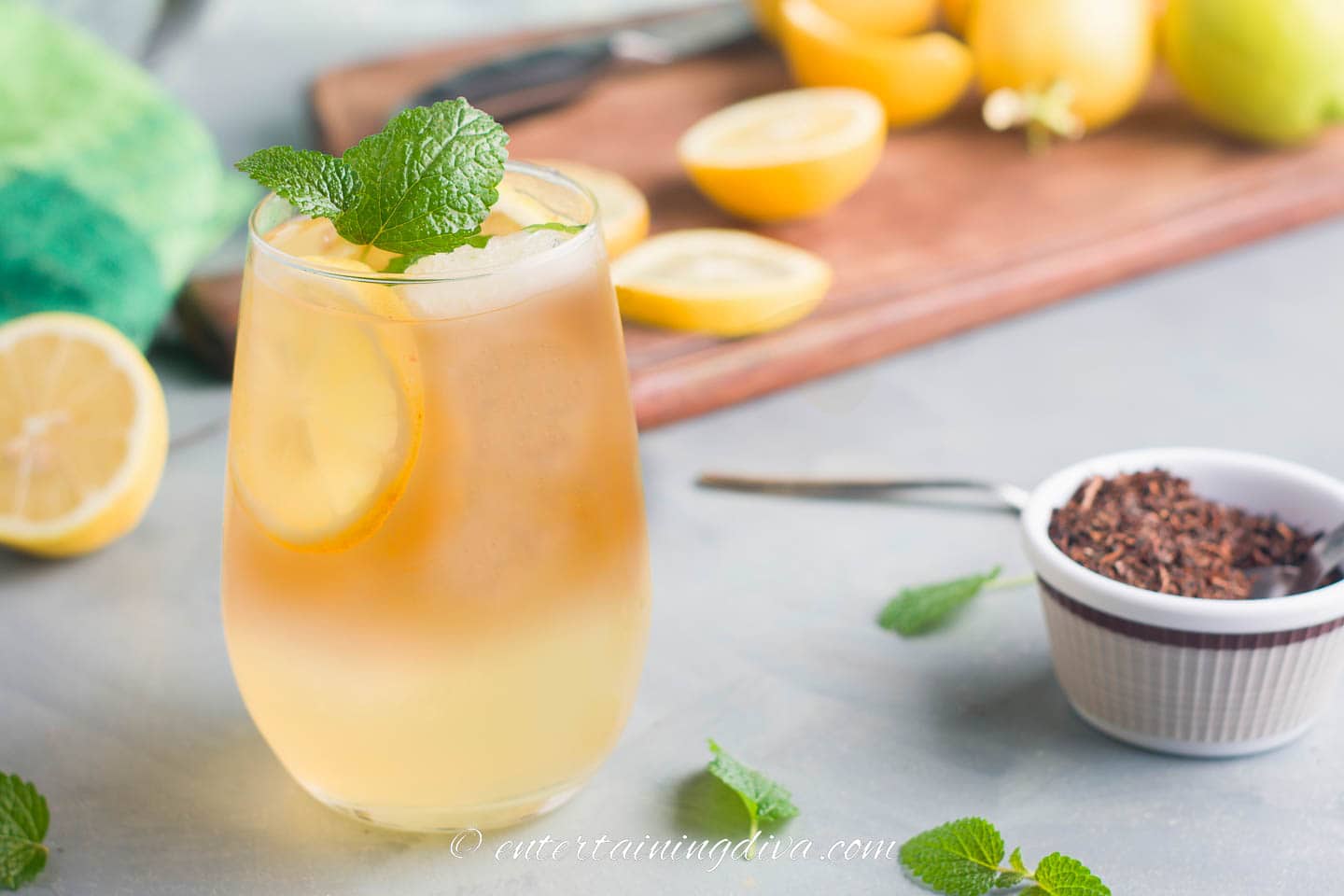 glass of iced tea with a lemon slice and sprig of fresh mint as a garnish