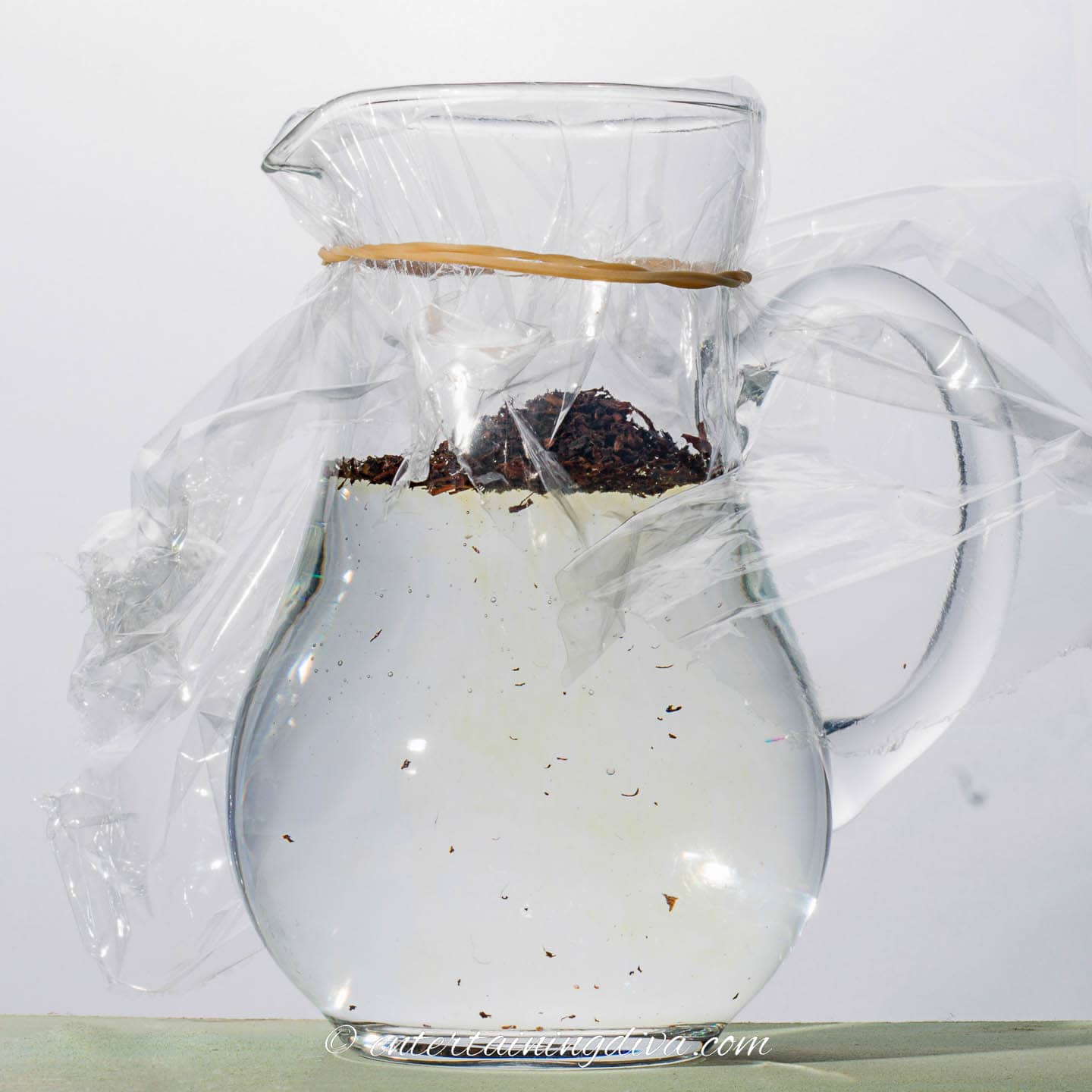 Tea leaves in a pitcher of cold water