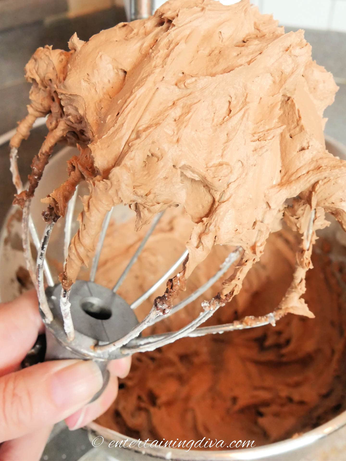 chocolate buttercream frosting on a whisk beater