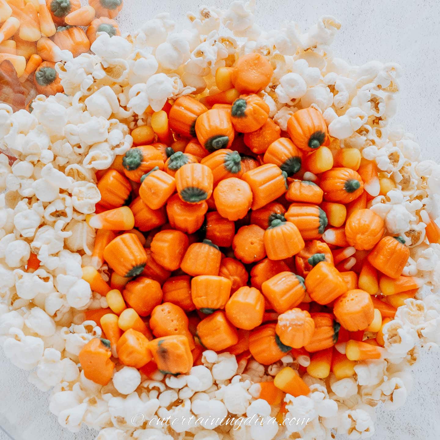 Popcorn and candy pumpkins in a bowl