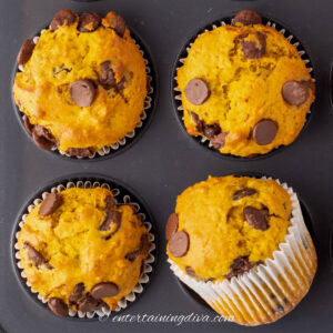 4 pumpkin chocolate chip muffins in a muffin tin