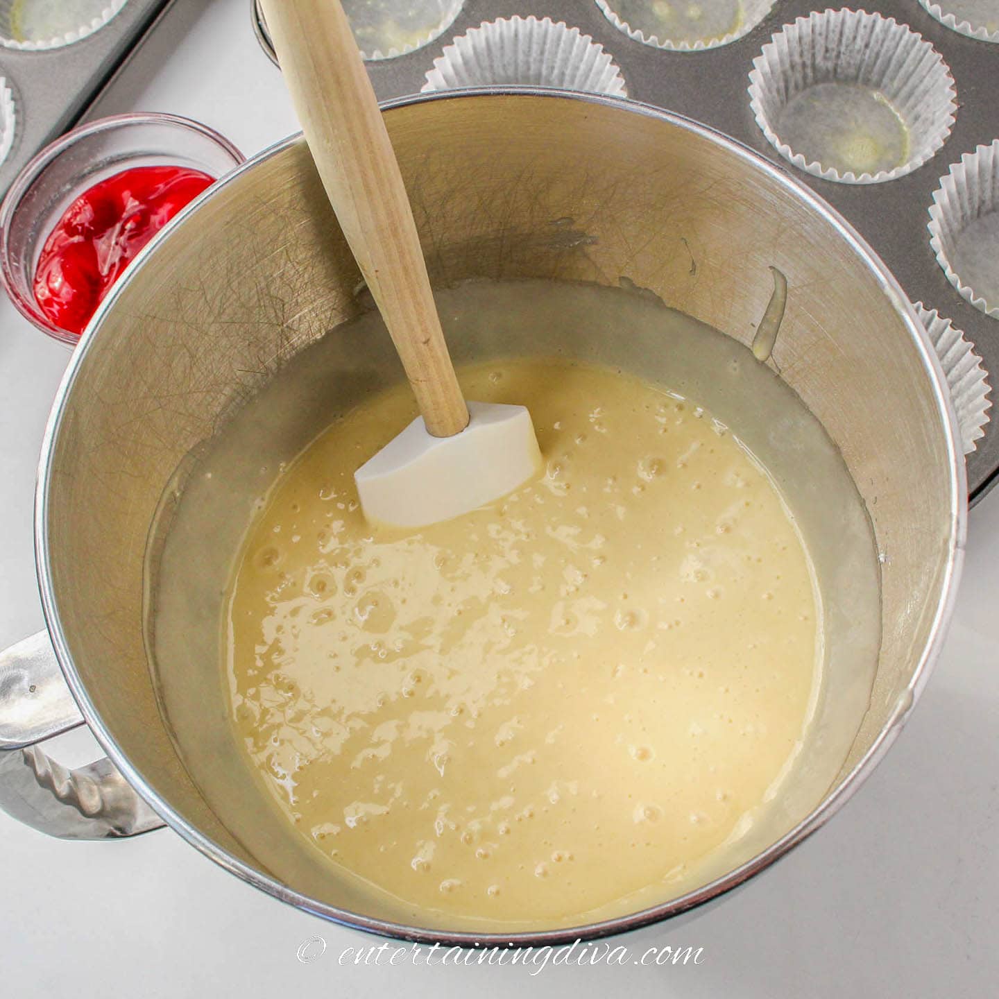 White cake batter in a bowl with a spatula