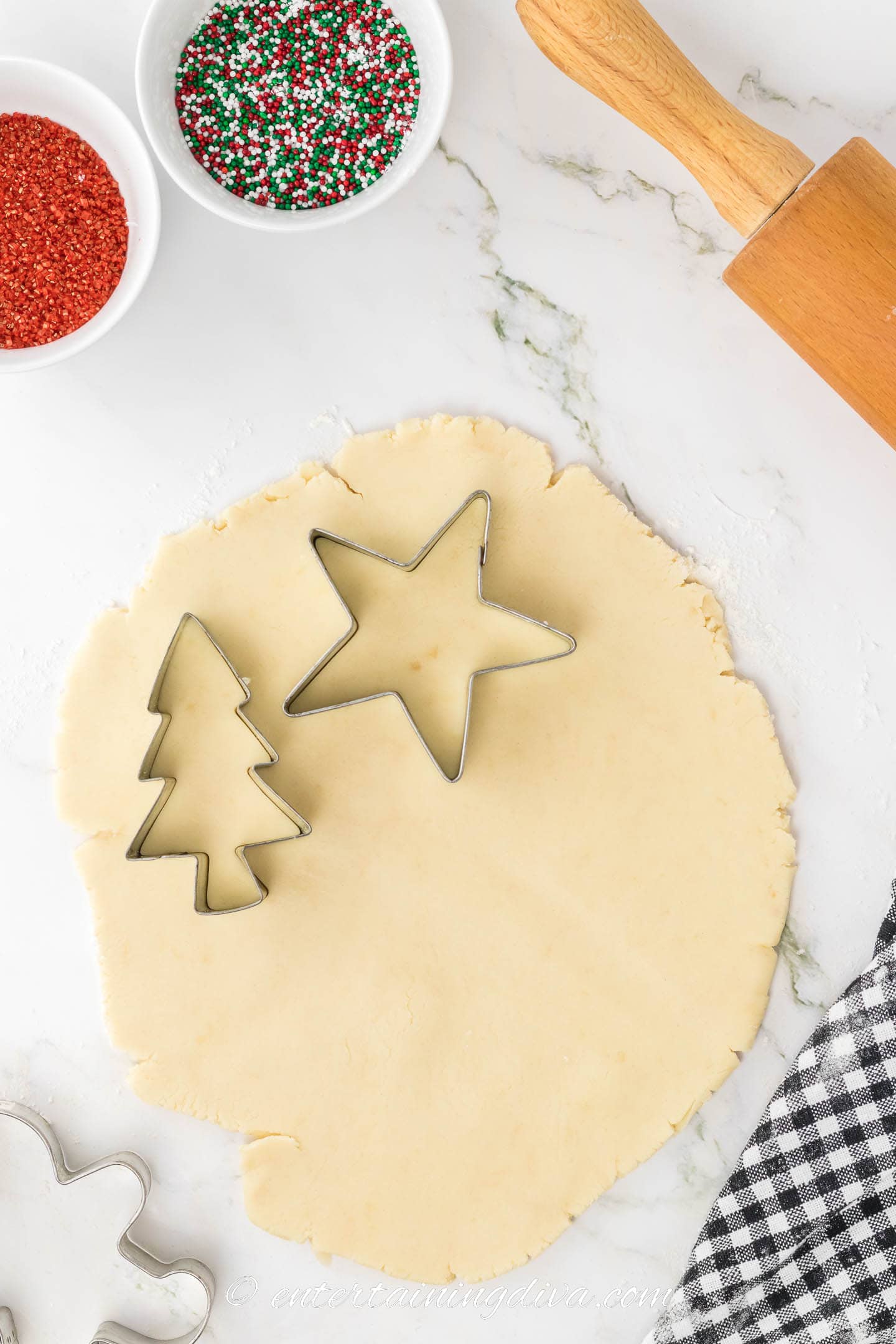 Shortbread cookie dough with Christmas tree and star cookie cutters