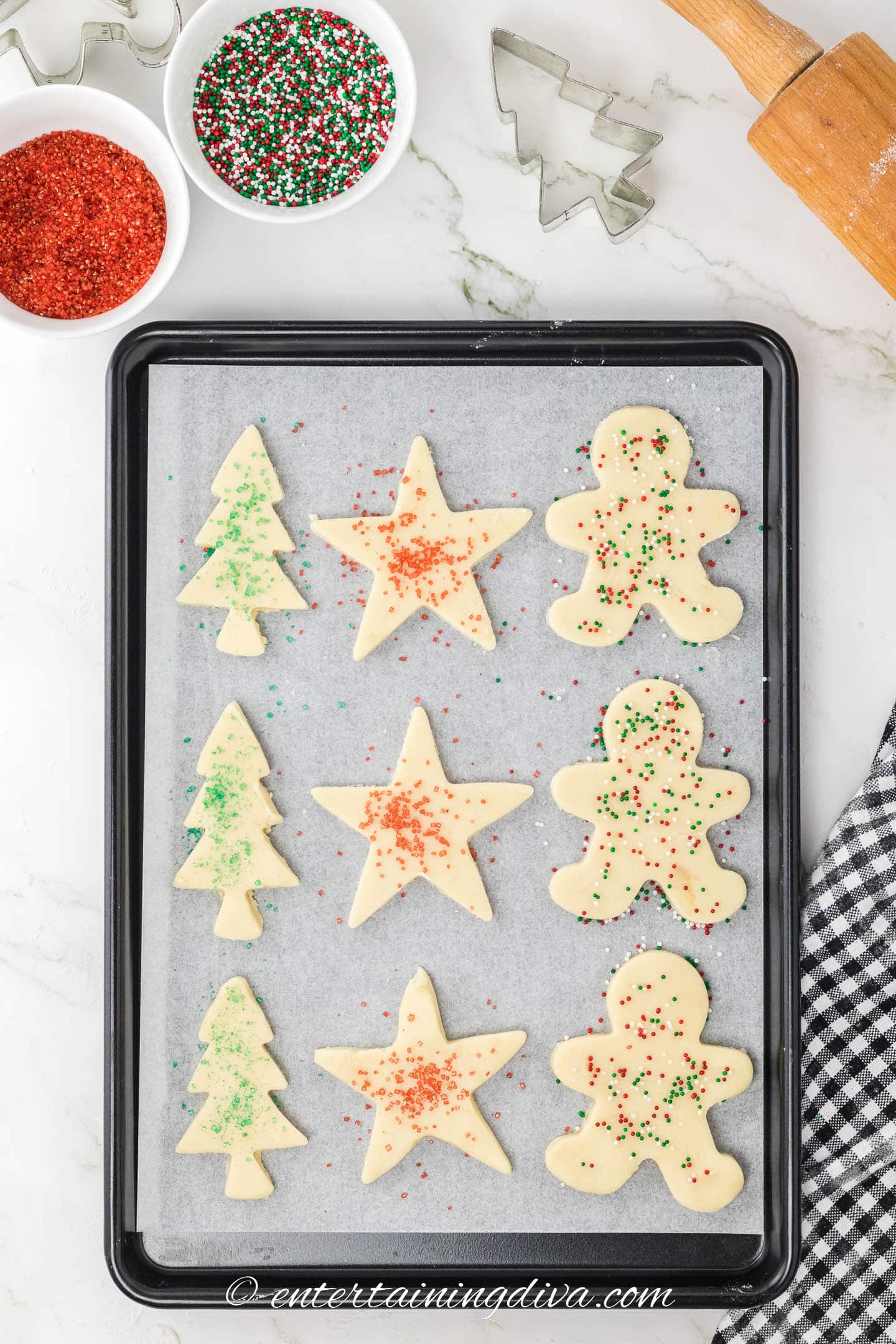 shortbread Christmas cookies with sprinkles on a baking sheet